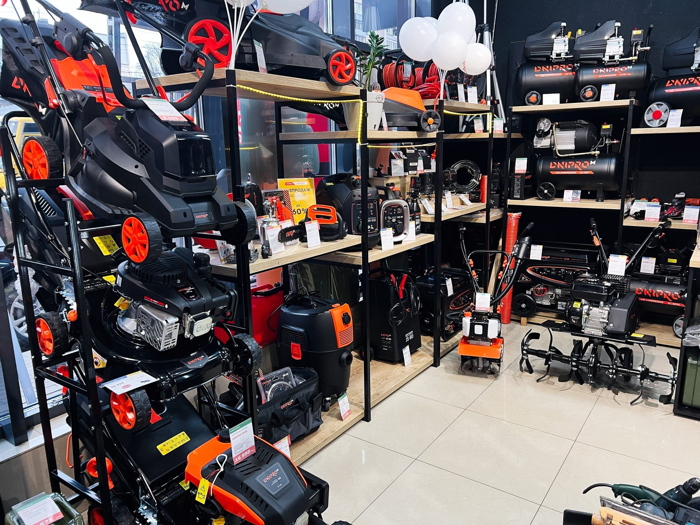 Shop shelves with lawn mowers and power tools