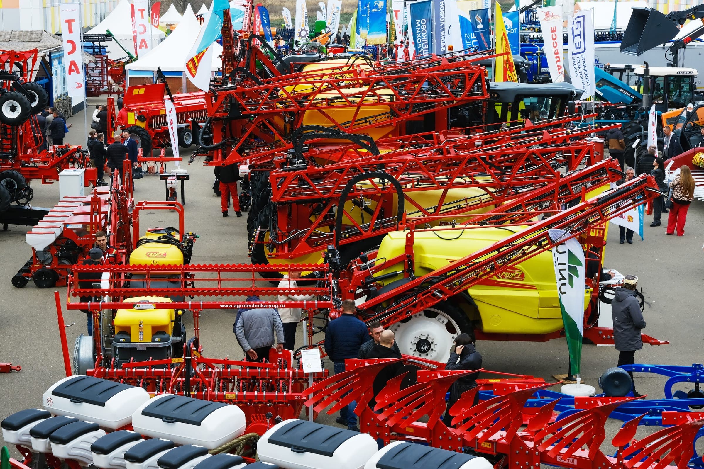 Hall of red tractor sprayers with folding booms